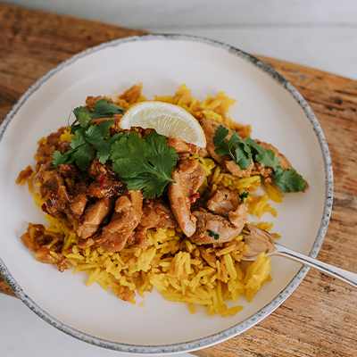 Waipawa Butchery Kitchen Singapore Chicken and Rice on a white plate, sitting on a chopping board.