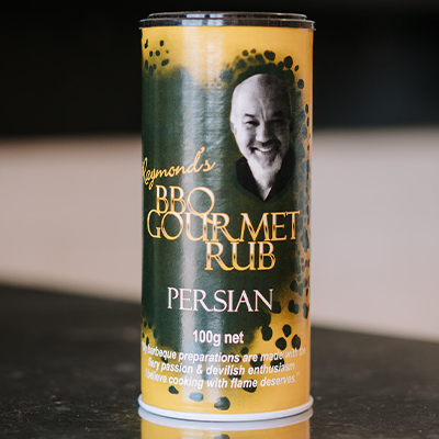 A shaker of Raymonds Rub Persian flavour sits on a counter top with a blurrred background.